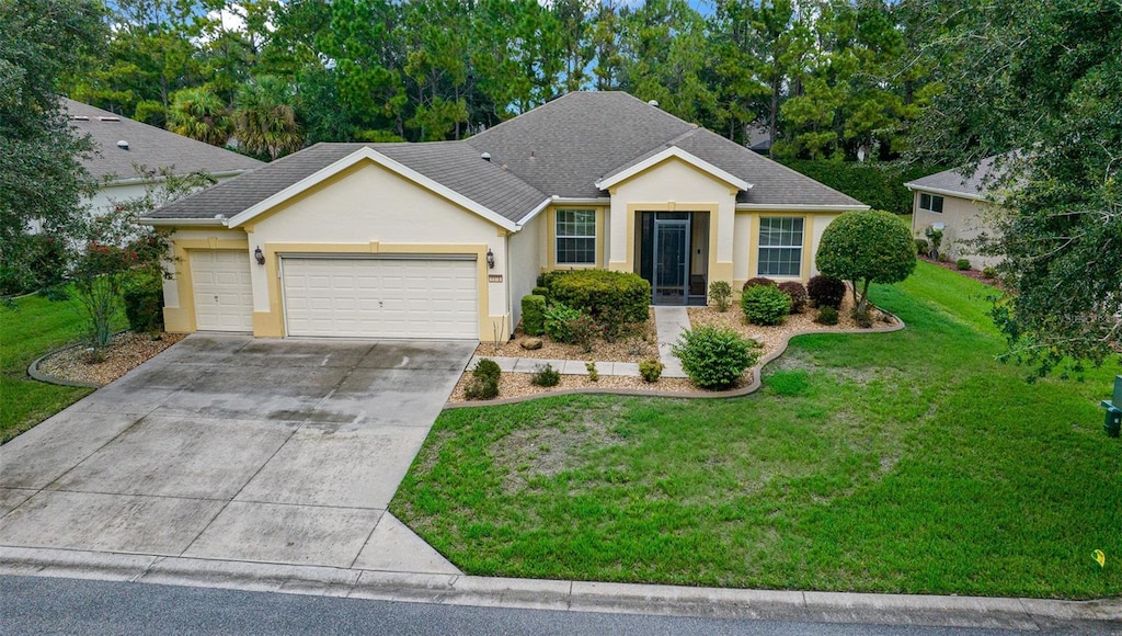 single story home with a garage and a front lawn