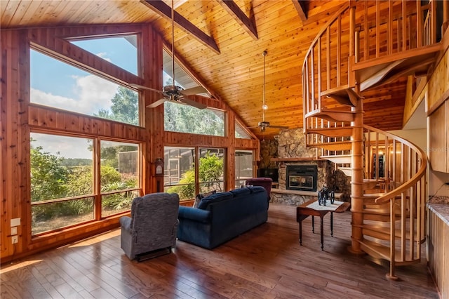 living room featuring a stone fireplace, hardwood / wood-style floors, ceiling fan, and high vaulted ceiling