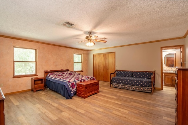 bedroom with light hardwood / wood-style floors, multiple windows, ceiling fan, and a textured ceiling