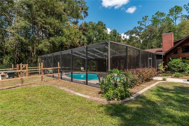 view of swimming pool with a lawn and glass enclosure