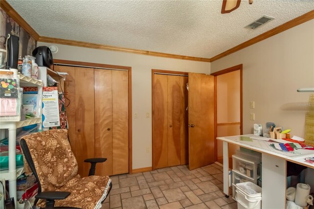 interior space with ornamental molding, a textured ceiling, and ceiling fan