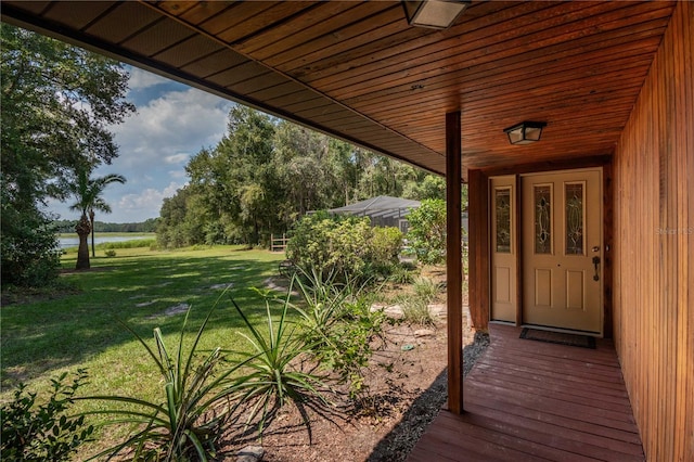 wooden terrace with a lawn