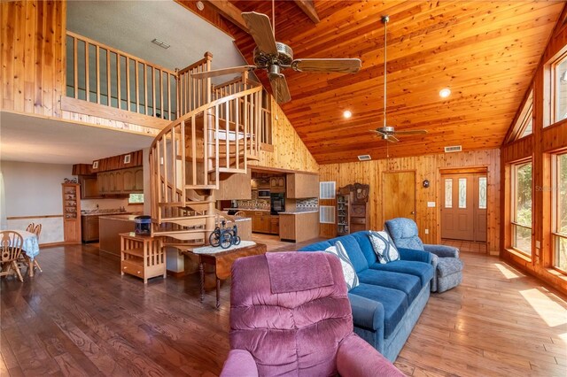 living room with ceiling fan, wood-type flooring, and high vaulted ceiling