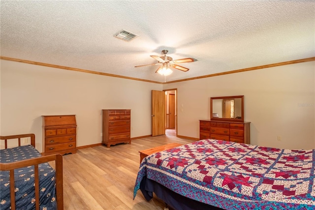 bedroom with ceiling fan, a textured ceiling, light wood-type flooring, and crown molding