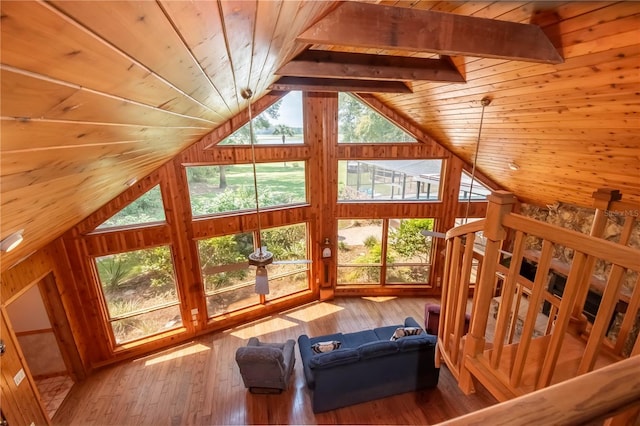 living room featuring a healthy amount of sunlight, wood-type flooring, lofted ceiling with beams, and wooden ceiling