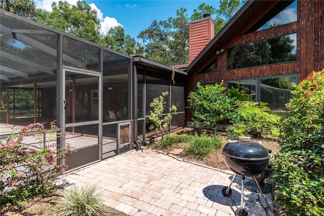 view of patio / terrace featuring glass enclosure