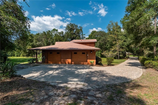 view of side of property with a yard and a garage