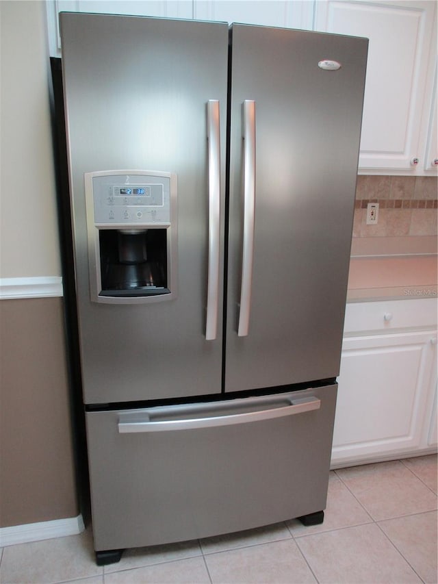 details featuring white cabinetry, stainless steel fridge with ice dispenser, and tasteful backsplash