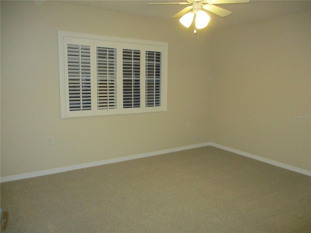 carpeted empty room featuring ceiling fan