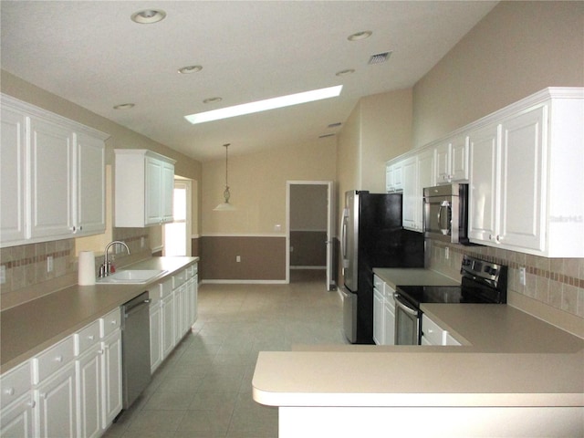 kitchen with stainless steel appliances, sink, white cabinets, and decorative backsplash