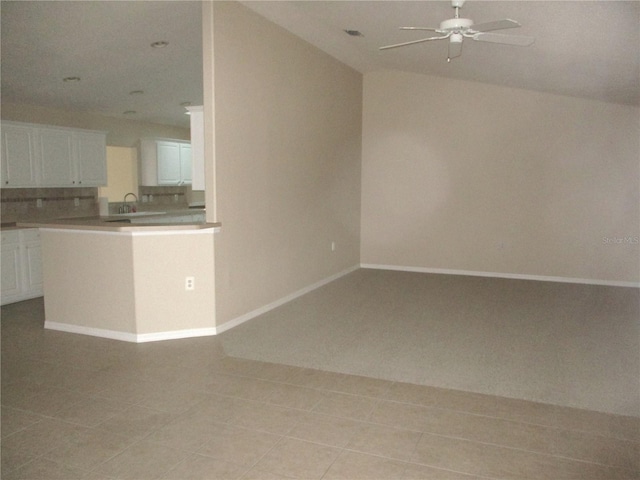 unfurnished living room featuring ceiling fan