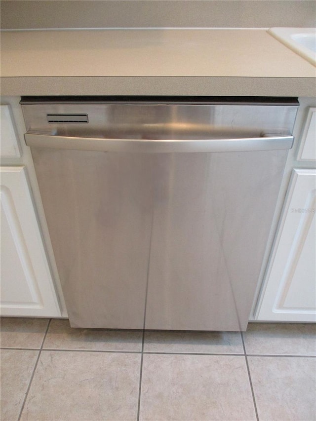 interior details with dishwasher and white cabinets