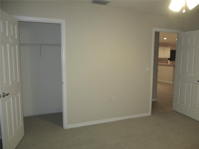 unfurnished bedroom featuring carpet floors and a closet