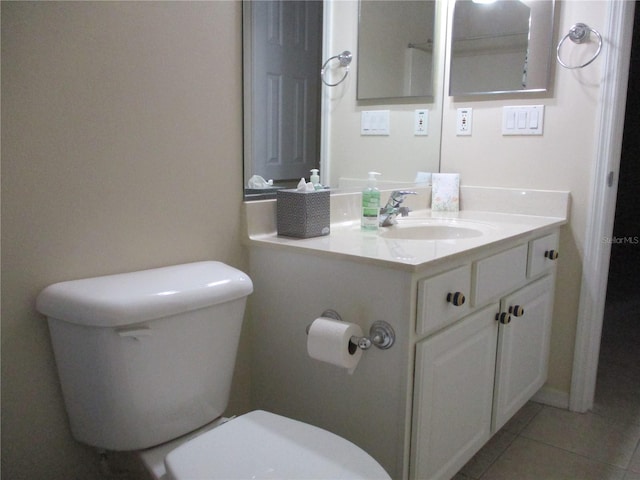 bathroom with vanity, tile patterned floors, and toilet