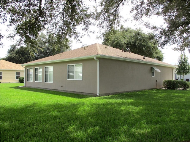 view of side of home featuring a lawn