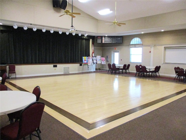 miscellaneous room with hardwood / wood-style flooring, ceiling fan, lofted ceiling, and basketball hoop