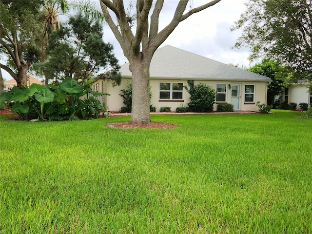 view of front of property with a front lawn and stucco siding