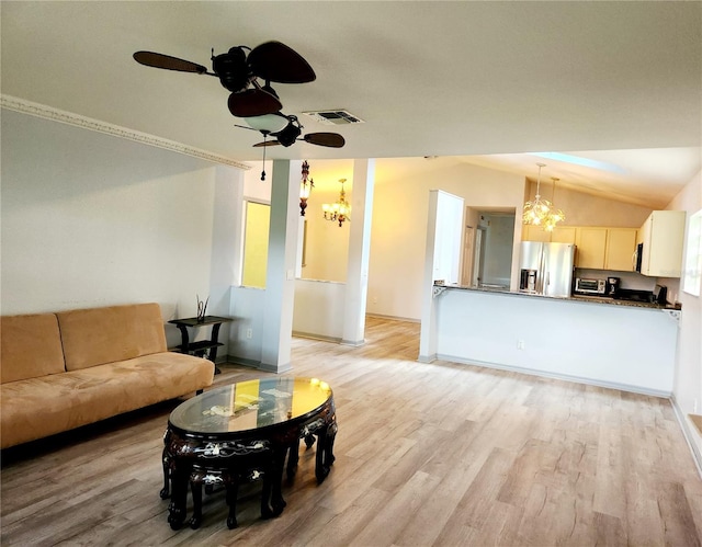 living room featuring light wood finished floors, ceiling fan, visible vents, and vaulted ceiling