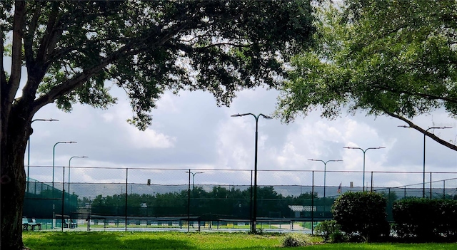 view of tennis court with fence