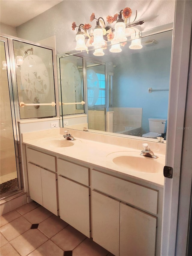 full bath with a stall shower, double vanity, a sink, and tile patterned floors