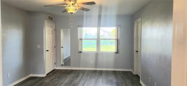 17808 SE 115th Ct, Summerfield, FL 34491 - spare room featuring dark wood-type flooring, a ceiling fan, and baseboards