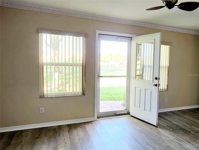 17808 SE 115th Ct, Summerfield, FL 34491 - foyer entrance with wood finished floors, a ceiling fan, crown molding, and baseboards