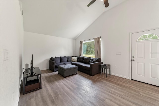 living room with a wealth of natural light, ceiling fan, and light wood-type flooring