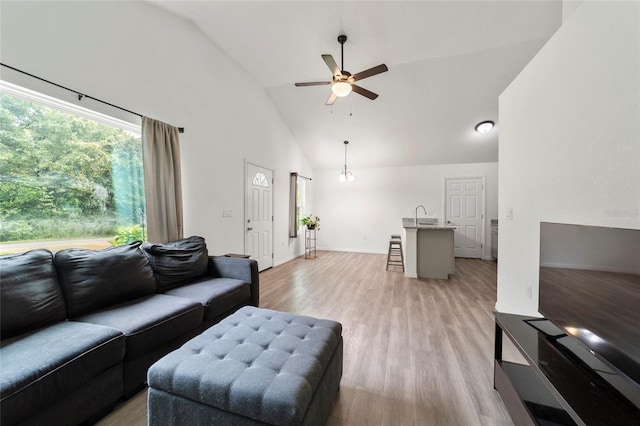 living room with high vaulted ceiling, sink, ceiling fan, and light hardwood / wood-style floors