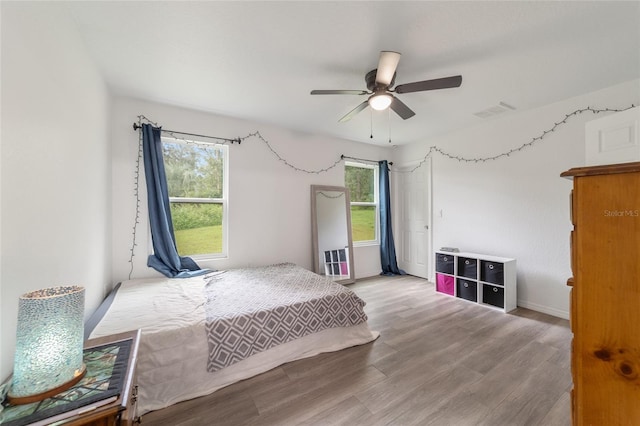 bedroom featuring hardwood / wood-style floors and ceiling fan