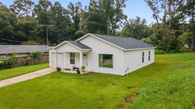 ranch-style home with a garage and a front lawn