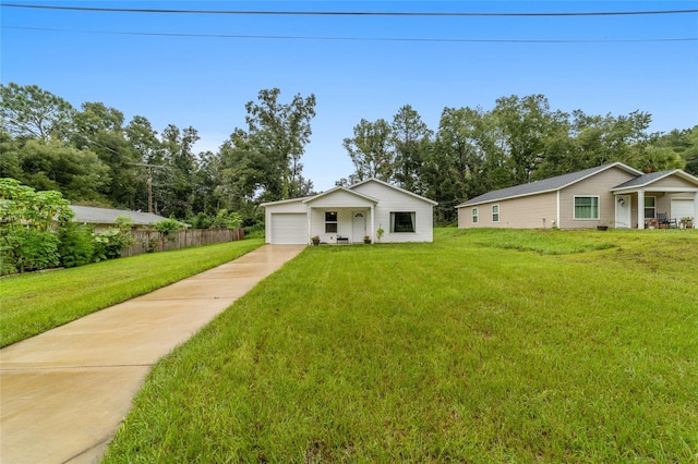 ranch-style house featuring a front yard and a garage