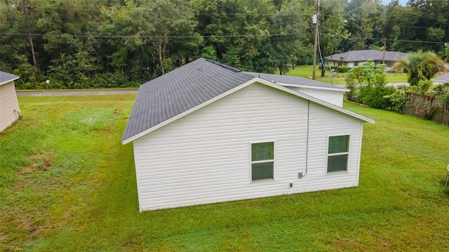 view of side of property with a lawn