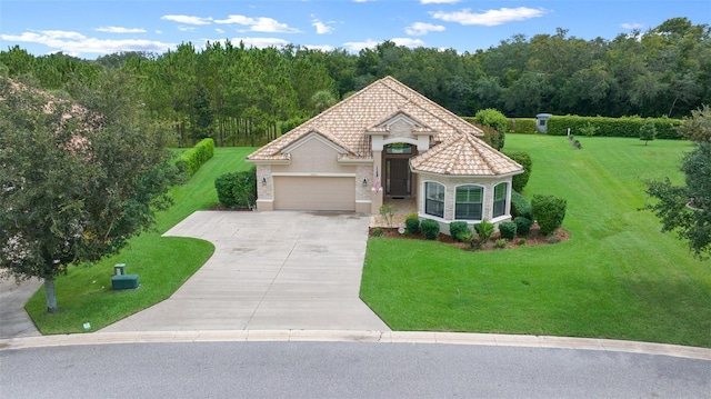 view of front of house featuring a front yard and a garage