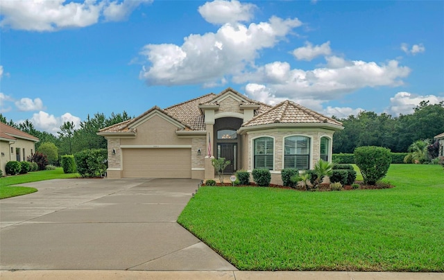 mediterranean / spanish-style house featuring a front lawn and a garage