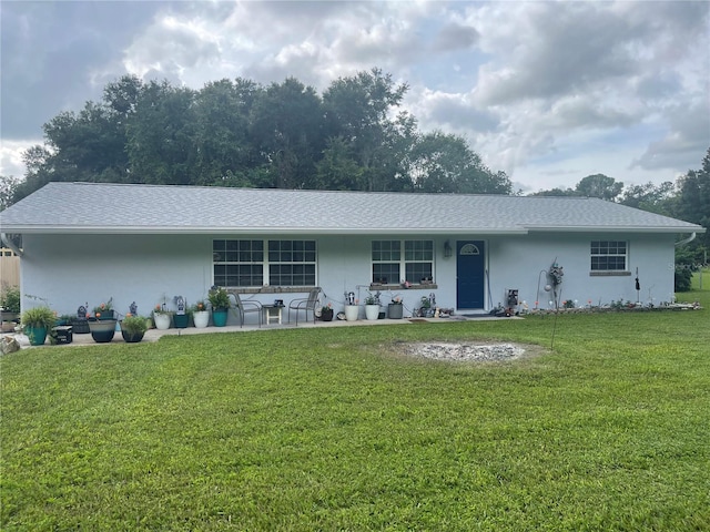 view of front of house featuring a front yard and a patio