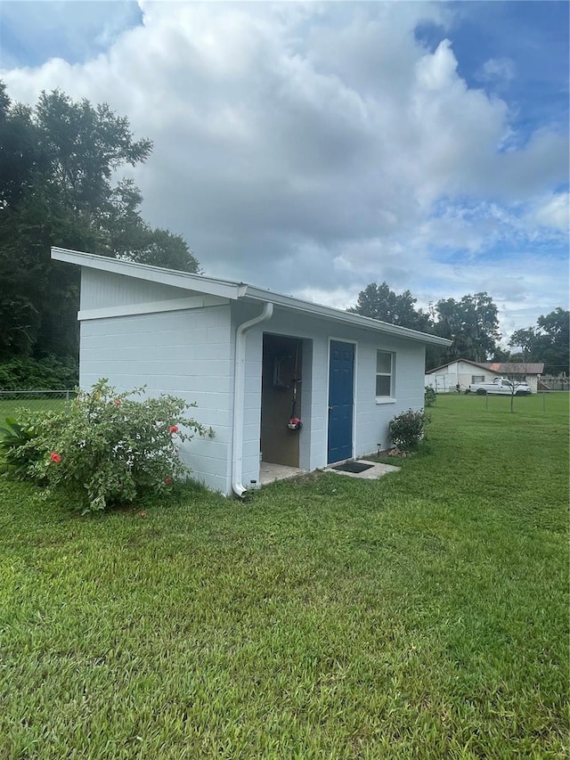 back of house with a lawn