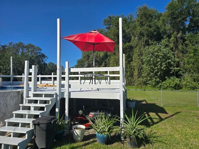 exterior space featuring a swimming pool and a lawn