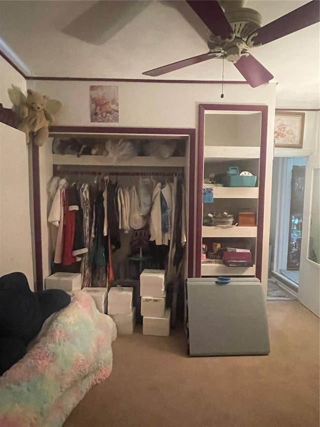 interior space featuring ceiling fan and a closet