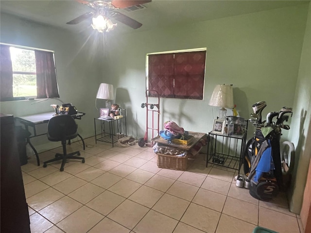 tiled home office featuring ceiling fan