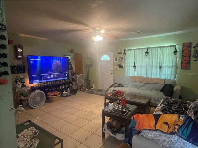 living room featuring ceiling fan and tile patterned flooring