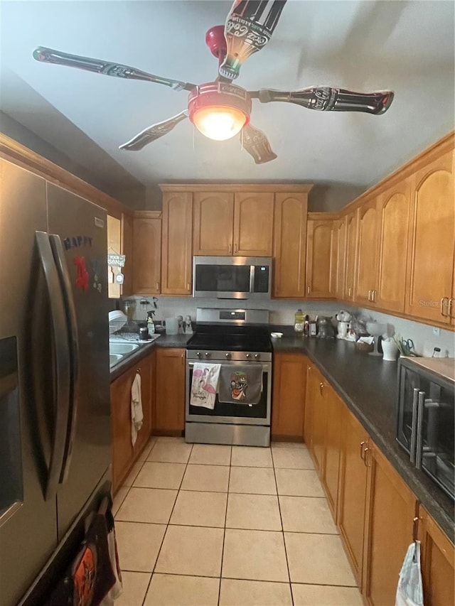 kitchen featuring appliances with stainless steel finishes and light tile patterned floors