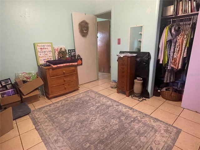 bedroom featuring light tile patterned flooring and a closet