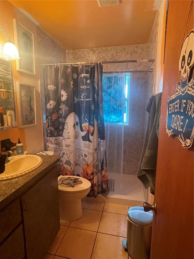 bathroom featuring curtained shower, tile patterned floors, vanity, and toilet