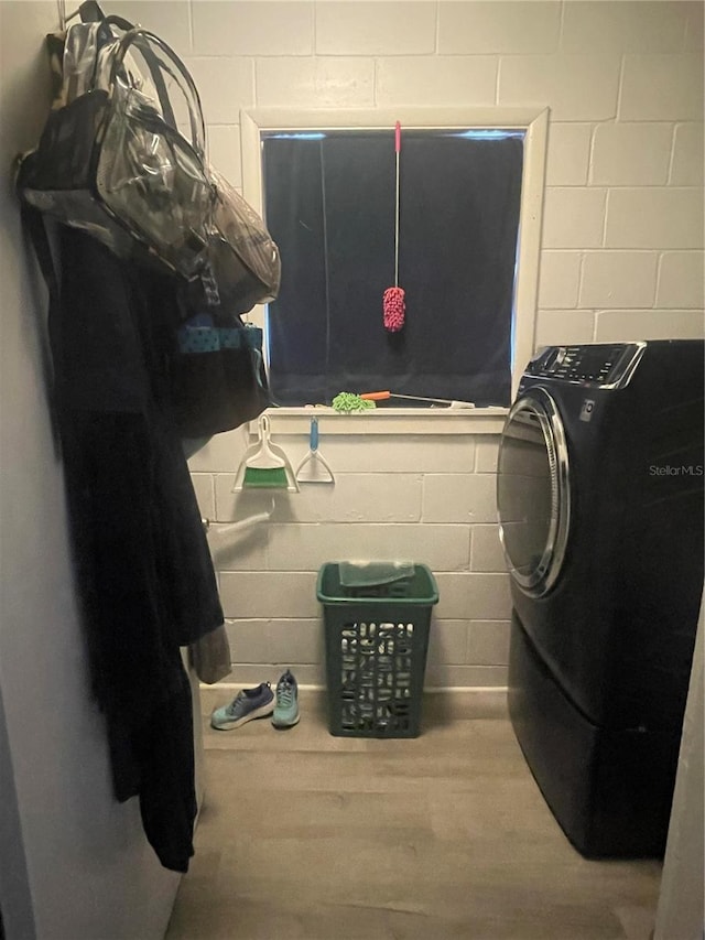 laundry room with hardwood / wood-style floors and washer / dryer