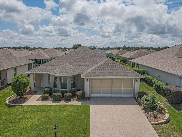 single story home featuring a front yard and a garage