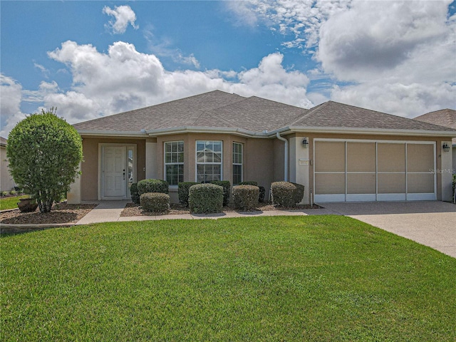 view of front of house featuring a garage and a front lawn