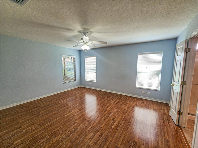 interior space with ceiling fan, dark hardwood / wood-style floors, and a textured ceiling