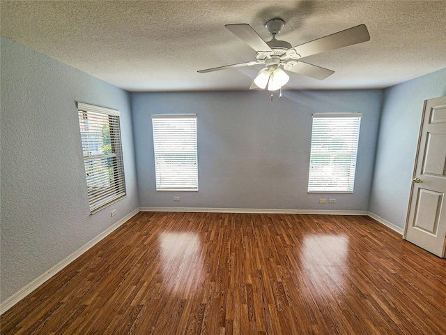 empty room with a textured ceiling, ceiling fan, and hardwood / wood-style flooring