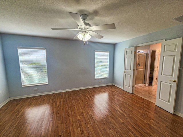 unfurnished bedroom featuring ceiling fan, hardwood / wood-style flooring, and a textured ceiling