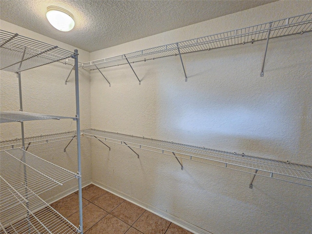 spacious closet featuring tile patterned flooring